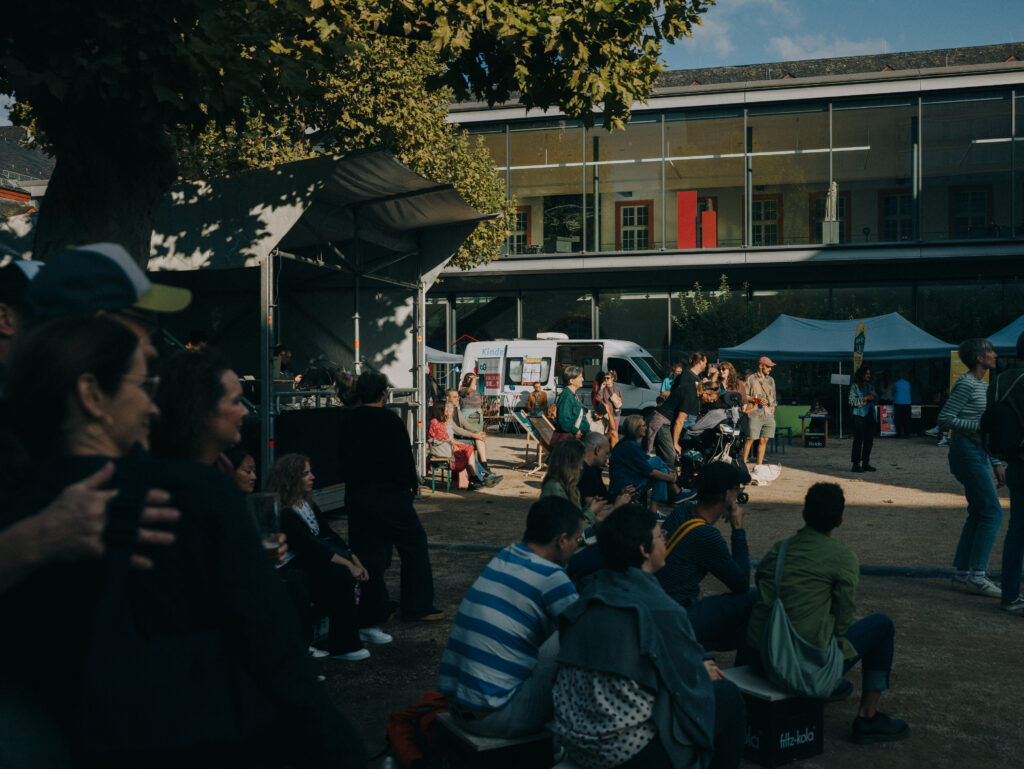 Gäste unterhalten sich beim Nie wieder ist jetzt-Minifestival im August 2026.